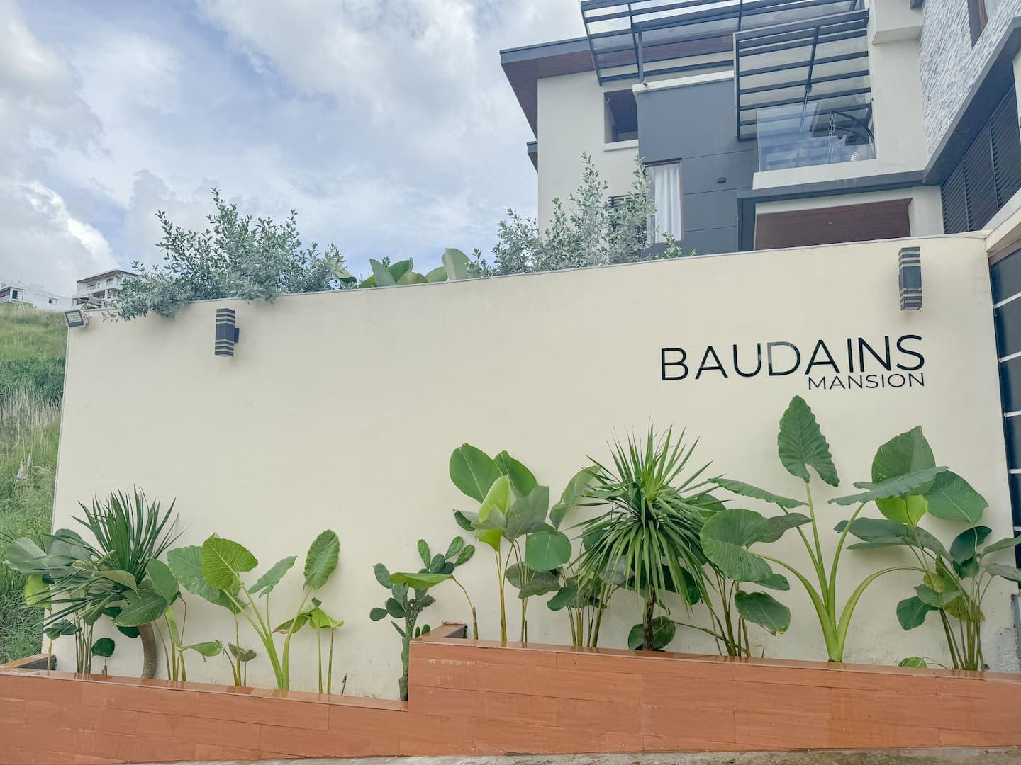 The Baudains Mansion sign at the gate